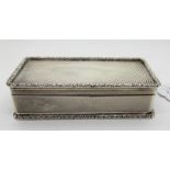 A silver snuff box, Birmingham 1962, of rectangular form with gadrooned edges and engine turned