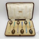 A cased set of six silver, gilt and enamel coffee spoons, Birmingham 1931 Condition Report: