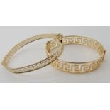 A 9ct gold Greek key pattern bangle inner dimensions 6cm x 5.3cm, together with a similar bangle