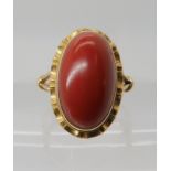 A bright yellow metal coral ring, dimensions of the coral 17.5mm x 10.4mm, finger size O, weight 6.