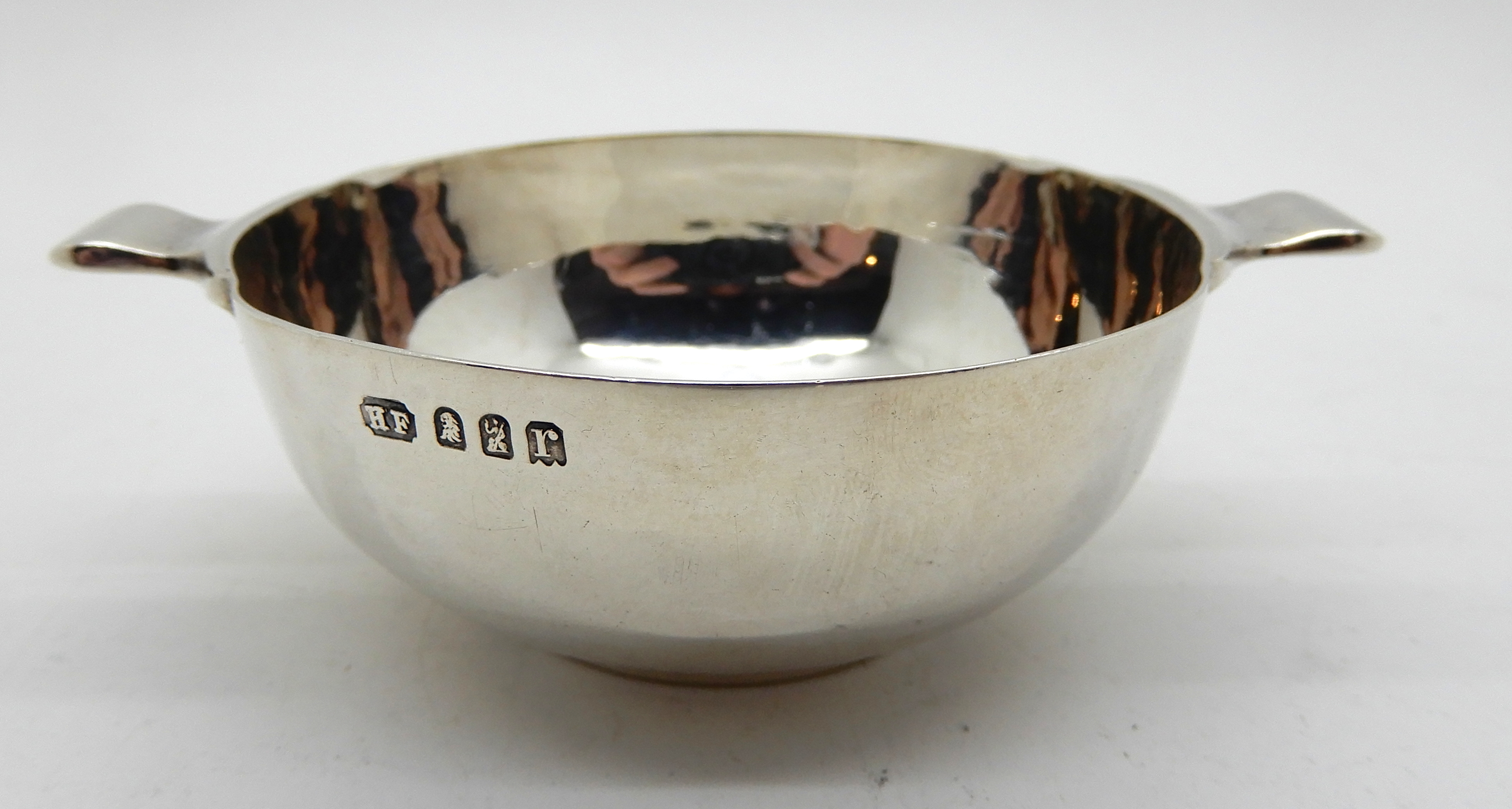 A silver quaich, London 1912, 9.5cm across the lugs, 47gms Condition Report: Available upon request