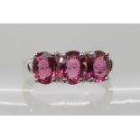 A 9ct white gold rubellite and diamond three stone ring size N, weight 3gms with GemsTV