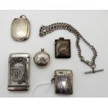 A lot comprising two silver vestas, a sovereign case (def), an Albert chain, compact and a white