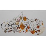 A collection of silver and amber jewellery to include a heart shaped lotus flower example and