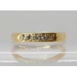 An 18ct gold five diamond band ring, size O1/2, weight 2.7gms Condition Report: Available upon
