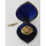 A yellow metal Victorian gem set brooch in original tooled leather box together with a 9ct gold blue