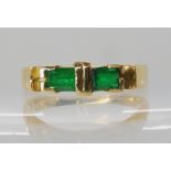 An 18ct gold twin emerald ring size Q, weight 4.2gms Condition Report: Available upon request