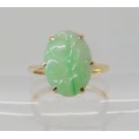 A 9ct gold Chinese green hardstone ring carved with fruit, size P, weight 2.8gms Condition Report: