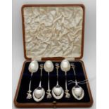 A cased set of six silver teaspoons, Birmingham 1915, the terminals modelled as mythical birds