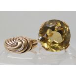 A yellow metal smoky quartz set ring size O1/2, and a 9ct gold wave design ring size R1/2, weight