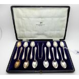 A cased set of twelve silver coffee spoons with tongs, Sheffield 1926 Condition Report: Available