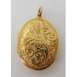 A yellow metal engraved locket dimensions 4.2cm x 2.6cm, weight 8.2gms Condition Report: Available