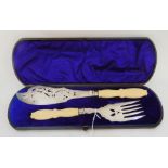 A cased pair of silver plate and ivorine handled fish servers Condition Report: Available upon