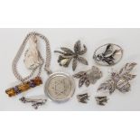 A collection of silver brooches to include a marcazite goldfish, bee set with amethyst and