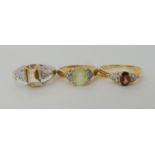 A 9ct gold citrine and white topaz ring size N1/2, a 9ct garnet and white topaz ring size O, and a