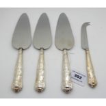 A lot comprising three silver handled cake slices and a silver handled cheese knife, Sheffield