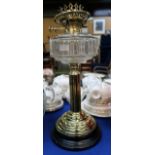 A brass oil lamp with glass font Condition Report: Available upon request