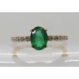 A 9ct gold emerald and diamond ring, emerald approx 7mm x 5mm x 3.6mm, diamond content approx 0.