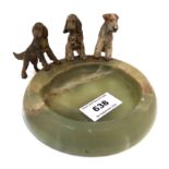 An onyx circular dish with cold painted spelter Spaniels and a Terrier, 13cm diameter Condition