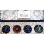 A boxed set of four Caithness planet paperweights designed by Colin Terris and made by Peter Holmes,