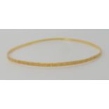 An 18ct gold diamond cut engraved bangle, inner diameter 6.5cm, weight 4.3gms Condition Report: