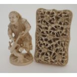 A JAPANESE IVORY OKIMONO OF A WOODSMAN standing with saw in hand and on a mound base, red seal mark,