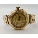 A 14K GOLD LADIES VINTAGE WATCH with pattern and floral engraved case, gold coloured dial, with