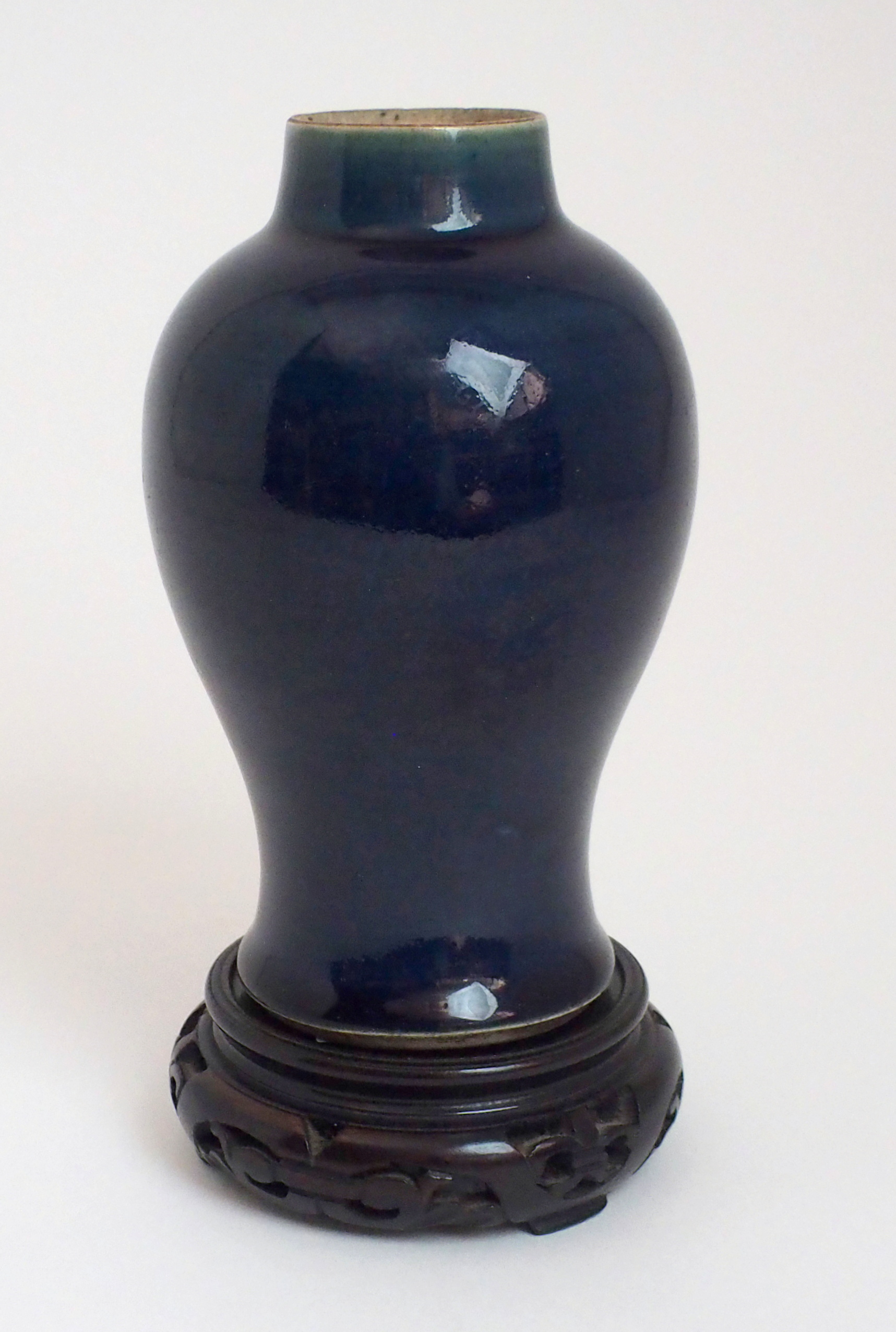 A CHINESE BLUE MONOCHROME BALUSTER VASE with traces of foliate gilding, 18th/19th Century, 17.5cm