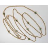 A LONG YELLOW METAL CHAIN SET WITH TURQUOISE length 136cm, the twist links set with the turquoise