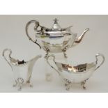 A THREE PIECE SILVER TEA SERVICE by James Ballantyne & Son, Glasgow 1921, of faceted oval form