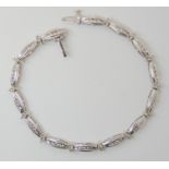 A 14K WHITE GOLD DIAMOND BRACELET set with estimated approximately 1ct of brilliant cut diamonds,