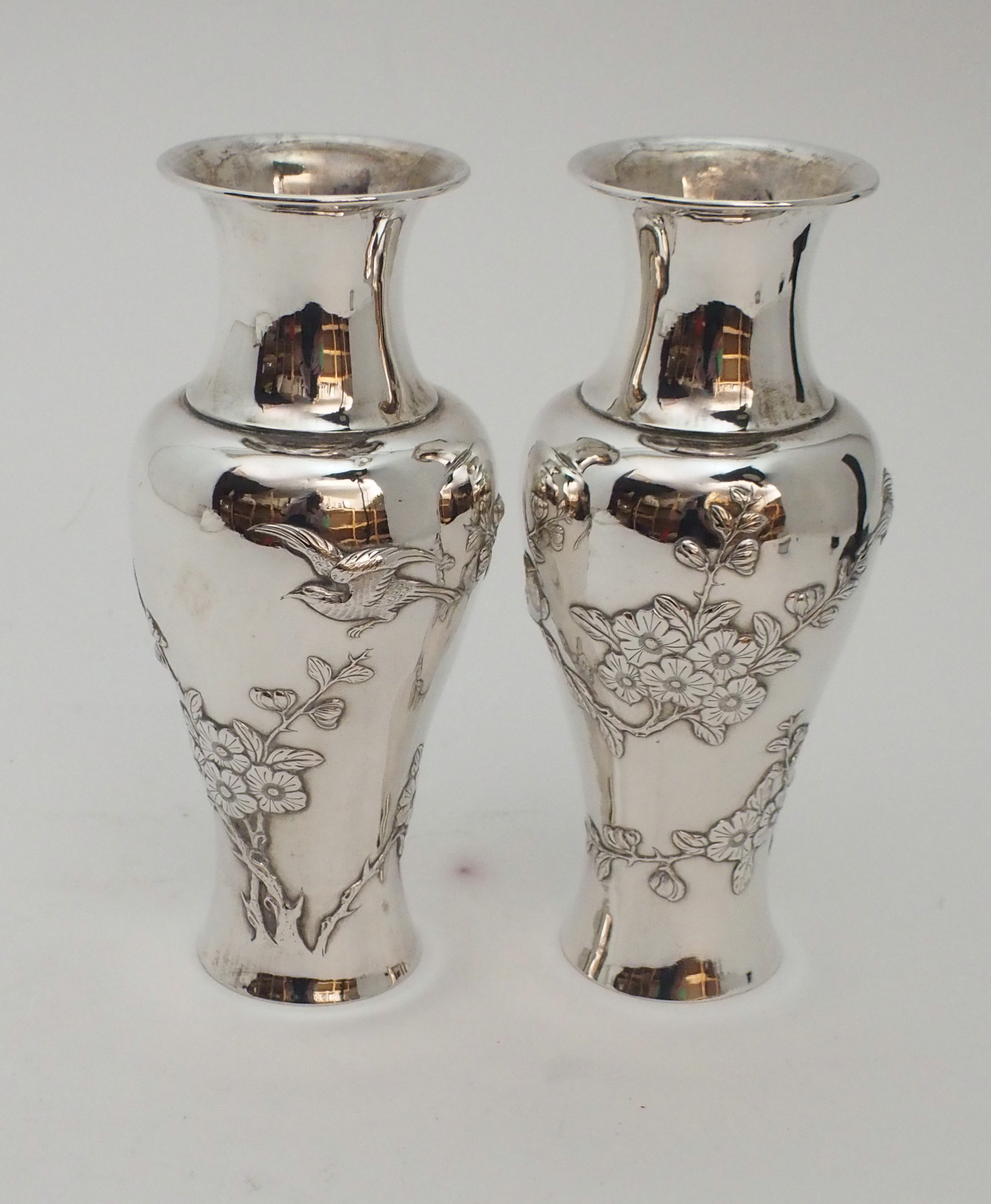 A PAIR OF CHINESE SILVER BALUSTER VASES decorated with birds amongst flowering branches, stamped