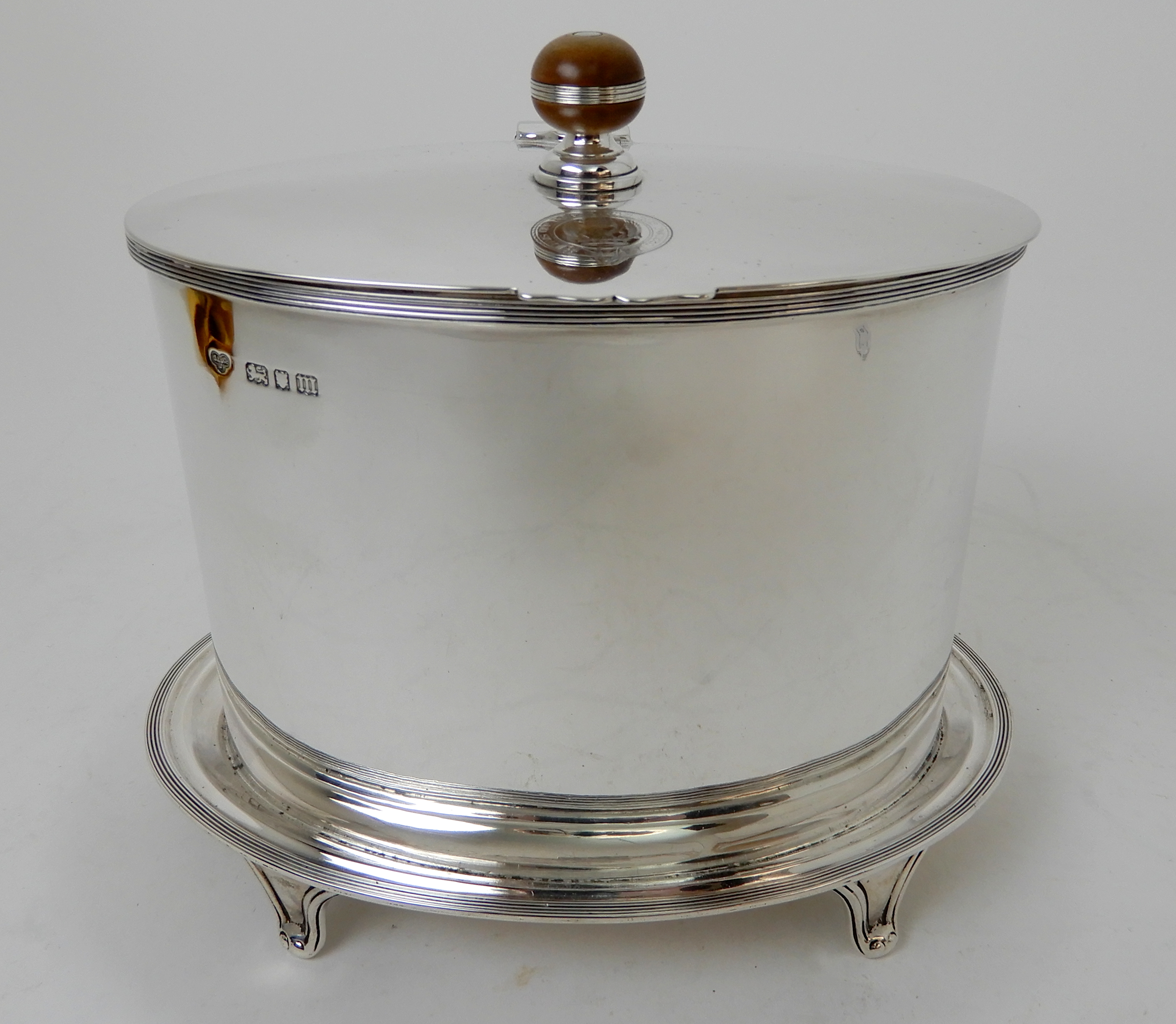 A SILVER BISCUIT BARREL maker's marks C & S Co. Limited, London 1927, of plain oval form, the hinged