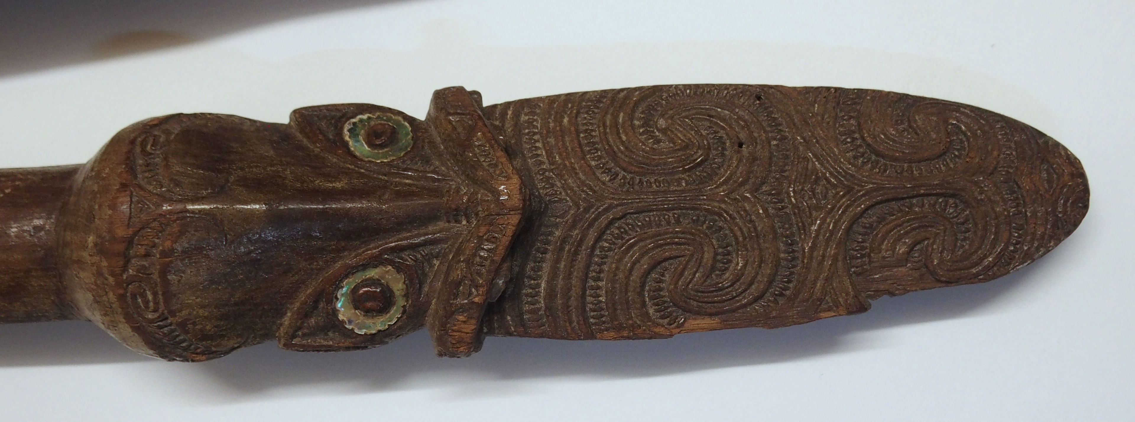 A MAORI PATU PADDLE the handle carved with grotesque masks inset with shell eyes and tribal - Image 2 of 10