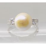 AN 18CT WHITE GOLD PEARL AND DIAMOND RING with wreath engraved shoulders, pearl approx 9mm in