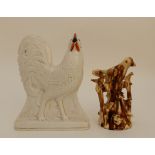 A 19TH CENTURY GLAZED POTTERY BIRD WHISTLE modelled as a bird perched on a fence with smaller