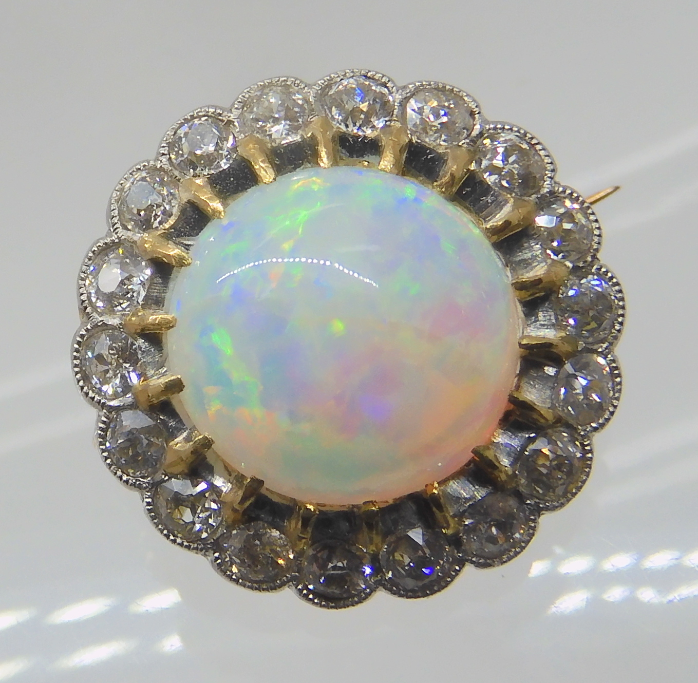 AN OPAL AND DIAMOND BROOCH opal approx 10.4mm in diameter, surrounded with a row of diamonds which - Image 3 of 6