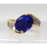 AN 18CT GOLD TANZANITE AND DIAMOND DRESS RING set with an oval tanzanite of approx 10mm x 7.9mm x