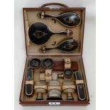 A TRAVEL TOILET CASE fitted with silver and tortoiseshell topped jars, bottles and three piece
