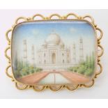 A YELLOW METAL BROOCH MOUNTED MINIATURE OF THE TAJ MAHAL dimensions of glazed picture 2.8cm x 2.1cm,