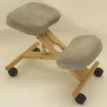 A WOODEN ORTHOPEDIC KNEELING STOOL upholstered in gray Estate of Alasdair Gray Condition Report: