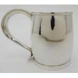 A HAMMERED SILVER TANKARD maker's marks HV, London 1946, of plain baluster form with scrolling