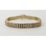 A 14K GOLD THREE ROW DIAMOND LINE BRACELET set with estimated approx 4.5cts of brilliant cut