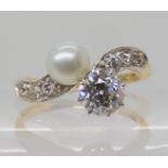 AN 18CT DIAMOND AND PEARL RING the main diamond is estimated at 0.75cts with old cut diamonds to