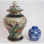 A CHINESE FAMILLE ROSE CRACKLEWARE JAR AND COVER painted with birds amongst foliage issuing from