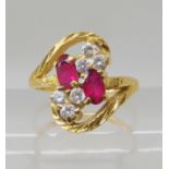 A BRIGHT YELLOW METAL RED AND CLEAR GEM SET RING finger size J1/2, weight 4gms Condition Report: