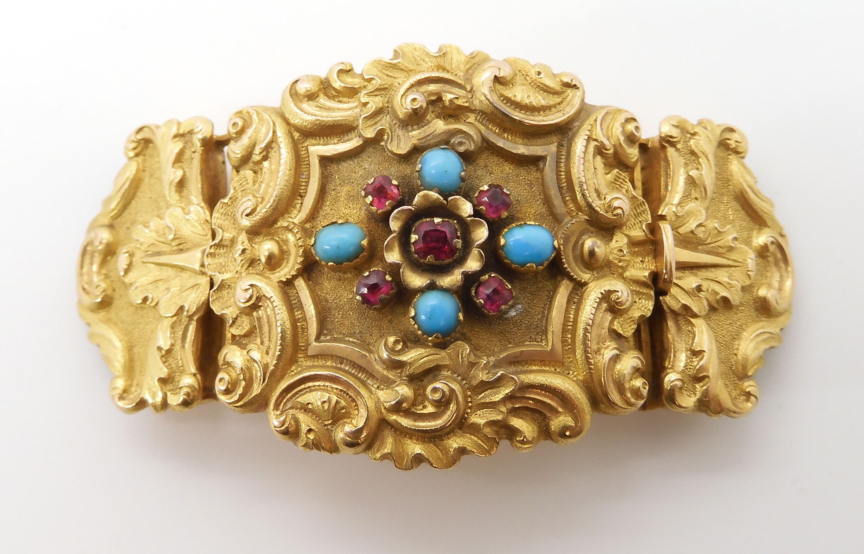 A BRIGHT YELLOW METAL CLASP SET WITH TURQUOISE AND RED GEMS with scroll, palmette and shell - Image 3 of 9