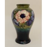 A MOORCROFT ANEMONE PATTERN VASE of bulbous tapering form, the green/blue ground with blue, purple