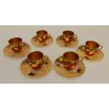 A SET OF ROYAL WORCESTER DEMITASSE CUPS AND SAUCERS comprising five fruit painted cups and saucers