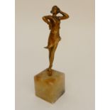 A PAINTED SPELTER FIGURE OF AN ART DECO DANCER mounted on an onyx cube, 28cm high Condition